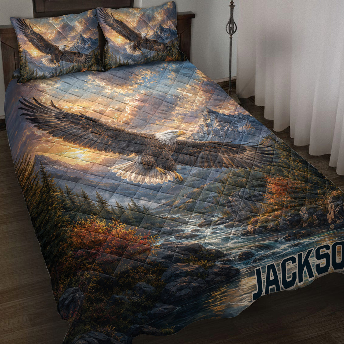 Eagle quilt blanket spread across a bed with mountain, forest, river, and sunrise wilderness artwork