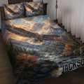 Eagle quilt blanket spread across a bed with mountain, forest, river, and sunrise wilderness artwork