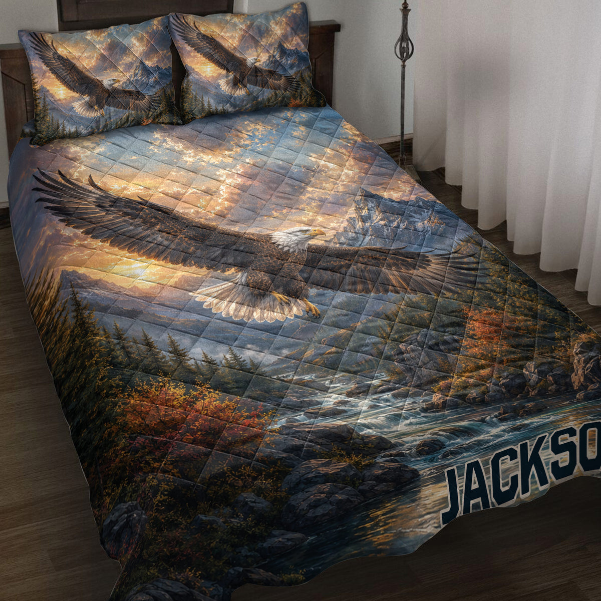 Eagle quilt blanket spread across a bed with mountain, forest, river, and sunrise wilderness artwork