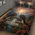 Close view of an eagle quilt blanket featuring paired eagles, mountain scenery, blossoms, and a flowing river