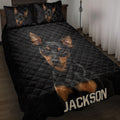 Black quilt blanket featuring multiple black-and-tan Miniature Pinscher portraits in a bedroom setting