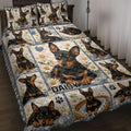 Miniature Pinscher quilt blanket displayed on a bed with daisies, paw prints, blue blocks, and heart accents