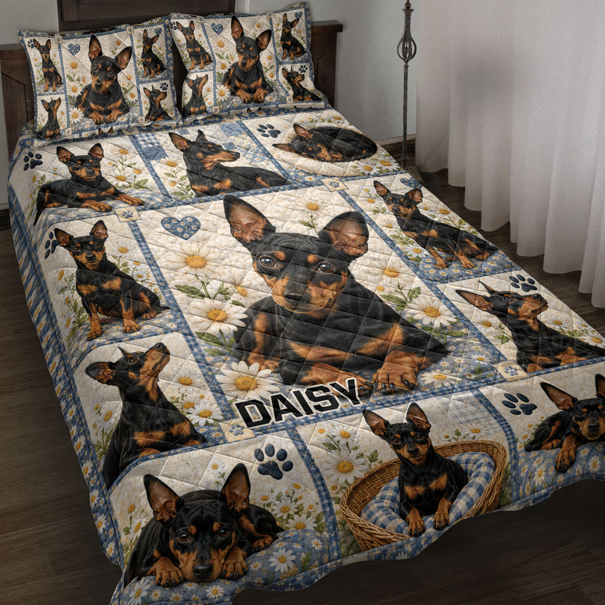 Miniature Pinscher quilt blanket displayed on a bed with daisies, paw prints, blue blocks, and heart accents