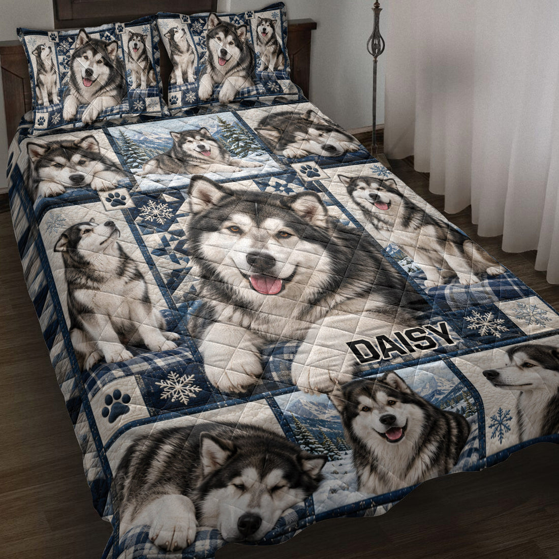 Alaskan Malamute quilt blanket displayed on a bed with snowy mountain scenes, paw prints, and blue plaid accents