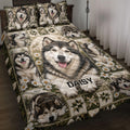 Alaskan Malamute quilt blanket displayed on a bed with daisy panels, patchwork stars, and multiple dog portraits