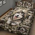 Close bedroom view of an Alaskan Malamute quilt with floral panels, rustic patchwork, and expressive dog portraits