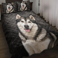 Alaskan Malamute quilt blanket displayed on a bed with matching dog portrait pillows