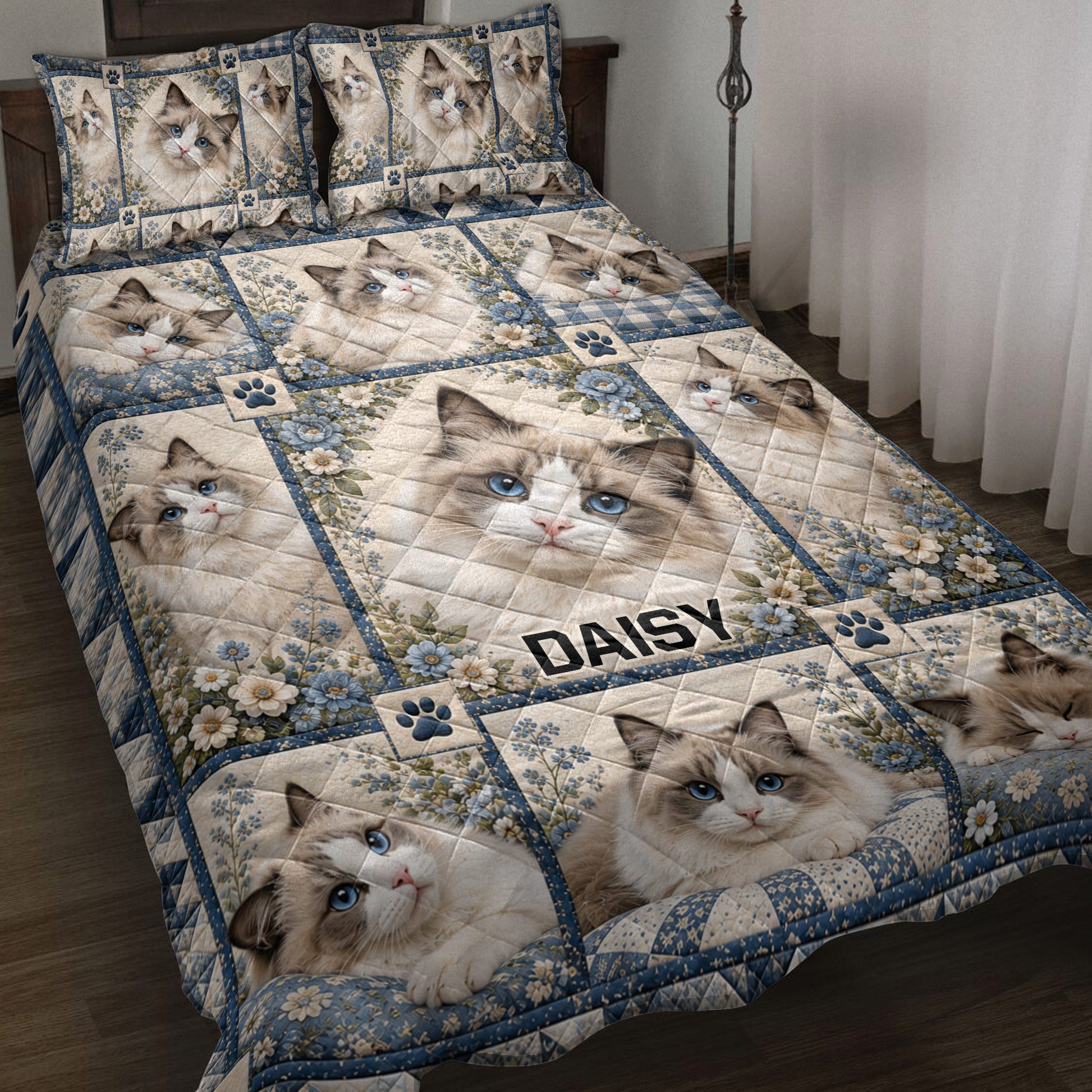 Ragdoll cat quilt blanket spread across a bed with blue flowers, paw prints, and blue borders