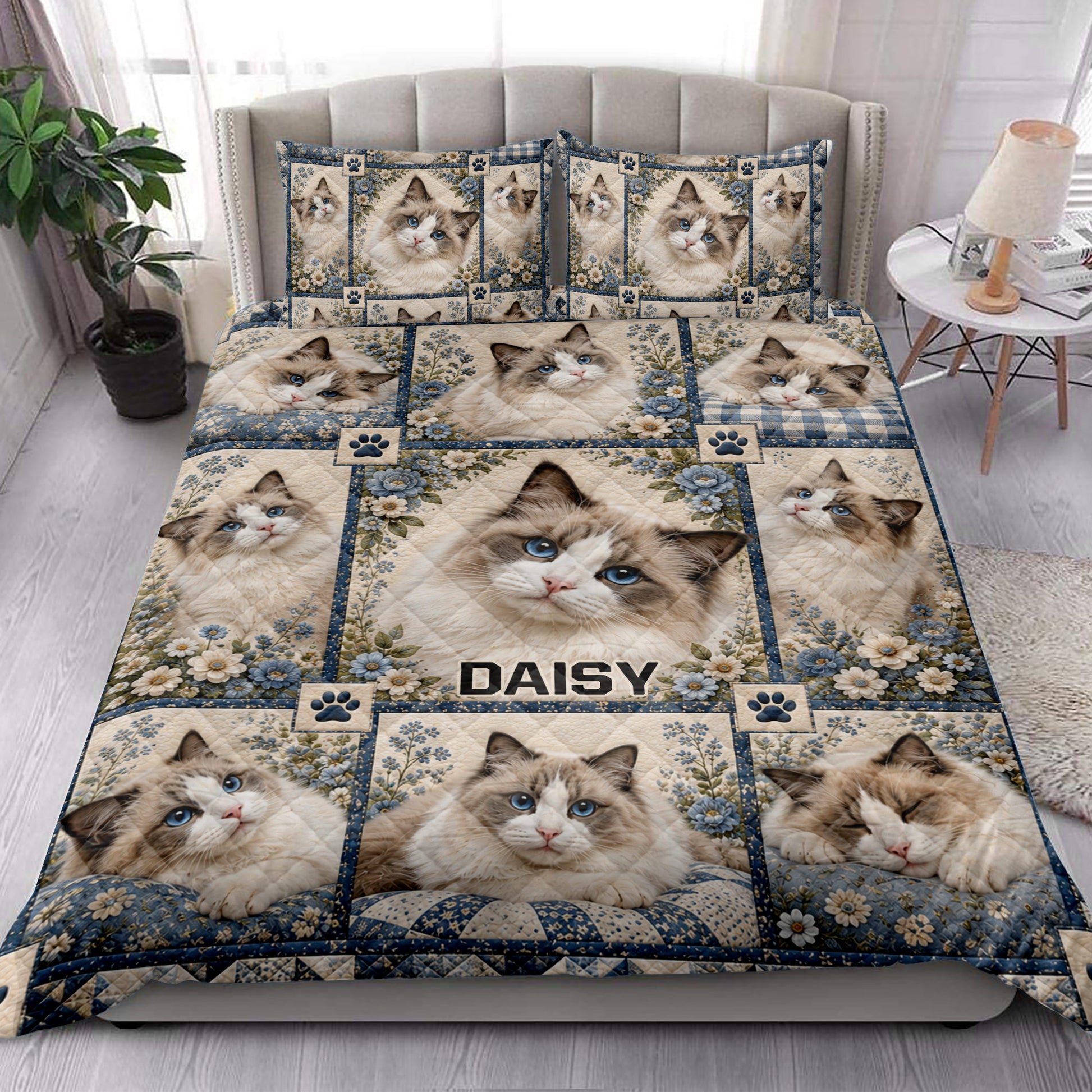 Ragdoll cat quilt blanket styled on a bed in a bright bedroom with floral blue accents