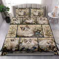 Ragdoll cat quilt blanket styled on a bed with floral panels, blue-eyed cats, and matching bedding accents