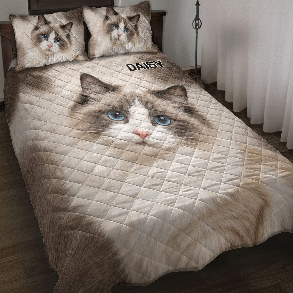 Ragdoll cat quilt blanket displayed on a bed with blue-eyed cat artwork and neutral diamond quilting