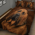 Close bedroom view of a Bloodhound quilt blanket with matching portrait pillows and brown fur texture