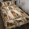 Bloodhound quilt blanket spread across a bed with repeated dog portraits and geometric patchwork artwork