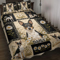 Rat Terrier quilt blanket with black and cream floral panels displayed on a bedroom bed