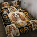 Cavalier King Charles Spaniel quilt blanket displayed on a bed with sunflower panels and dark botanical borders
