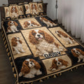 Cavalier King Charles Spaniel quilt blanket displayed on a bed with matching dog artwork and geometric borders