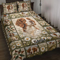 Brittany Spaniel quilt blanket displayed on a bed with daisy fields, patchwork blocks, and dog portraits