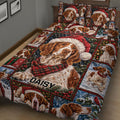 Brittany Spaniel holiday quilt blanket displayed across a bed with Santa hats, scarves, snow, and Christmas trees