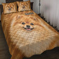 Pomeranian quilt blanket displayed on a bed with matching dog portrait pillow designs