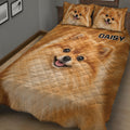Close bedroom view of a Pomeranian quilt blanket with large dog portrait artwork