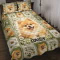 Pomeranian quilt blanket displayed on a bed with daisy panels and green floral borders