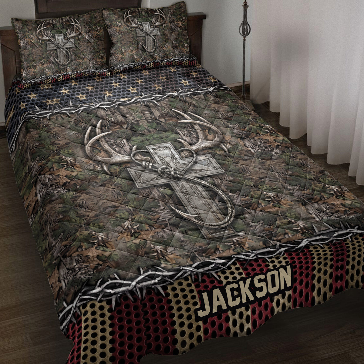 Hunting quilt blanket displayed on a bed with camouflage foliage, antlers, cross artwork, and rustic borders