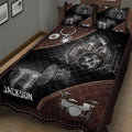 Close bedroom view of a drum quilt featuring a detailed silver drum kit and dark quilted background