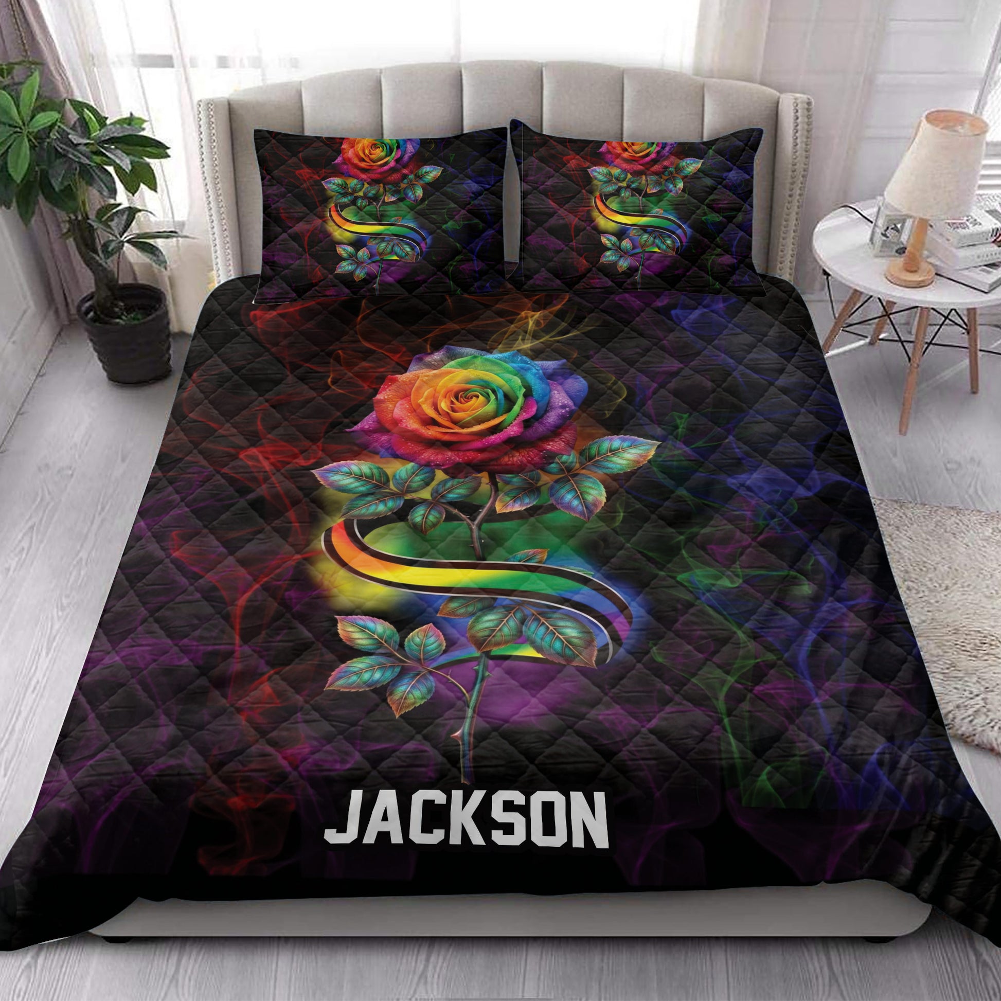 LGBT rainbow rose quilt bedding styled in a bright bedroom with colorful floral artwork