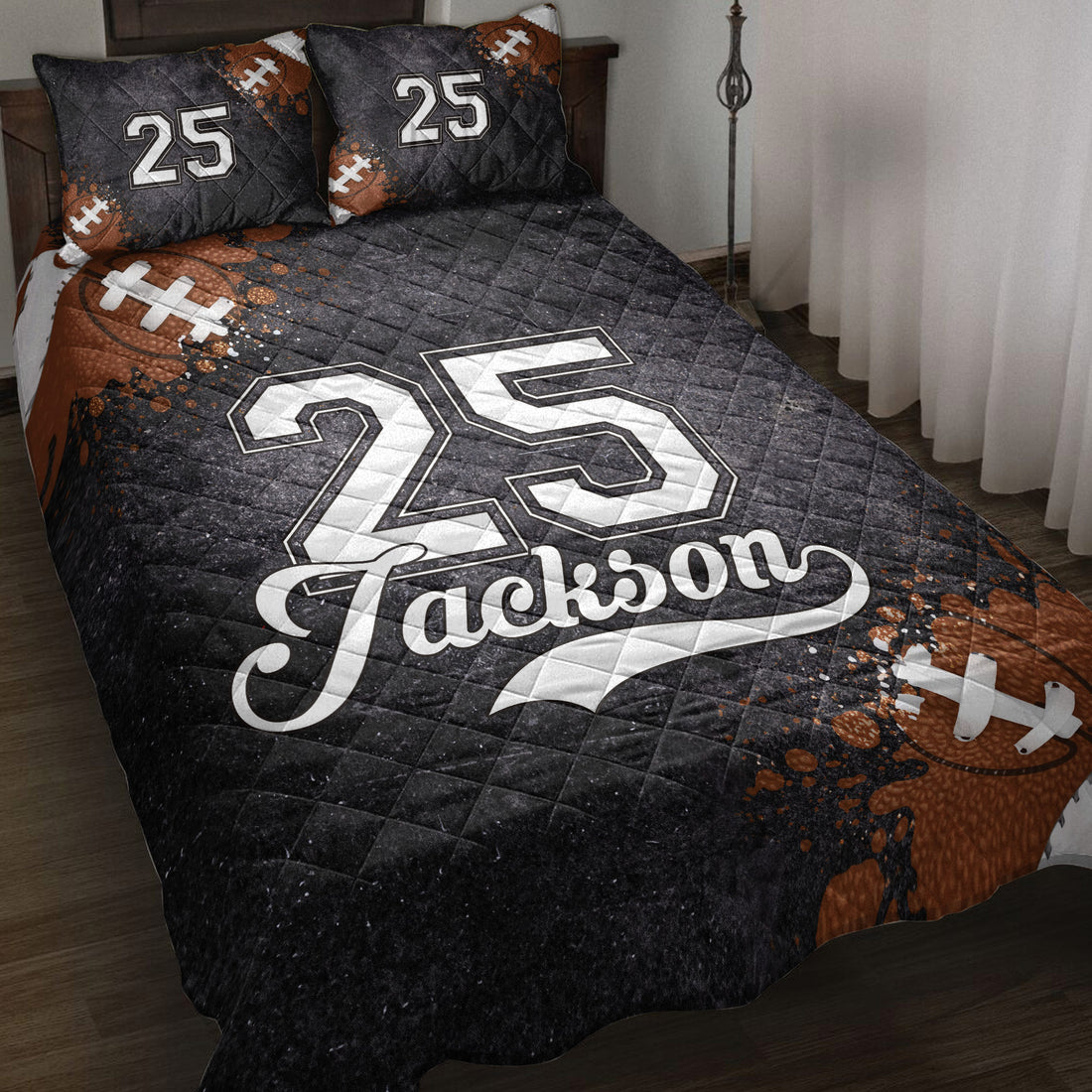Black football quilt blanket styled on a bed with football artwork and bold jersey-inspired graphics