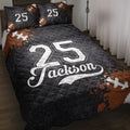 Black football quilt blanket styled on a bed with football artwork and bold jersey-inspired graphics