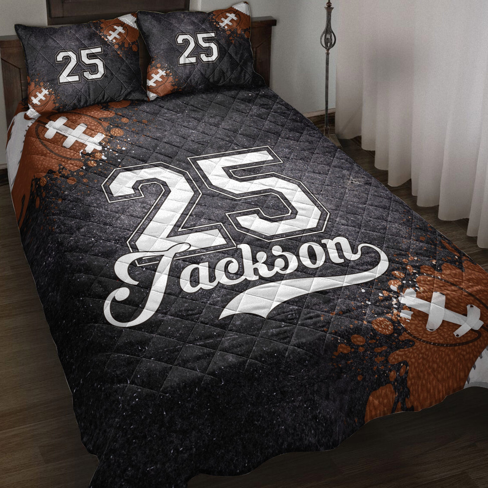 Black football quilt blanket styled on a bed with football artwork and bold jersey-inspired graphics