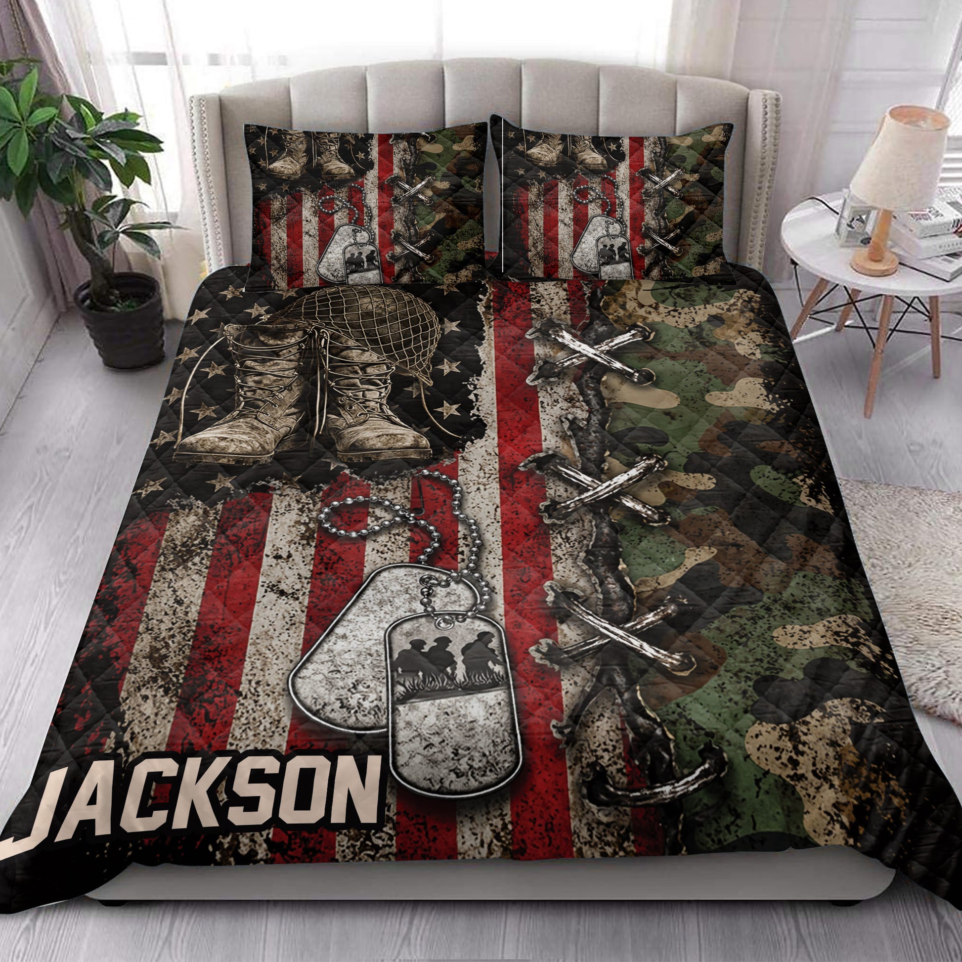 Veteran quilt blanket styled in a bedroom with military boots, dog tags, camouflage and red, white and blue artwork