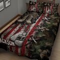 Military veteran quilt spread across a bed with combat boots, dog tags, crossed rifles and camouflage artwork