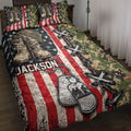 Veteran quilt blanket displayed on a bed with combat boots, camouflage, dog tags, and American flag artwork