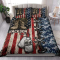 Veteran quilt blanket styled in a bedroom with combat boots, dog tags and patriotic military artwork