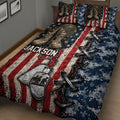 Military veteran quilt spread across a bed with camouflage, combat boots, dog tags and crossed rifle artwork
