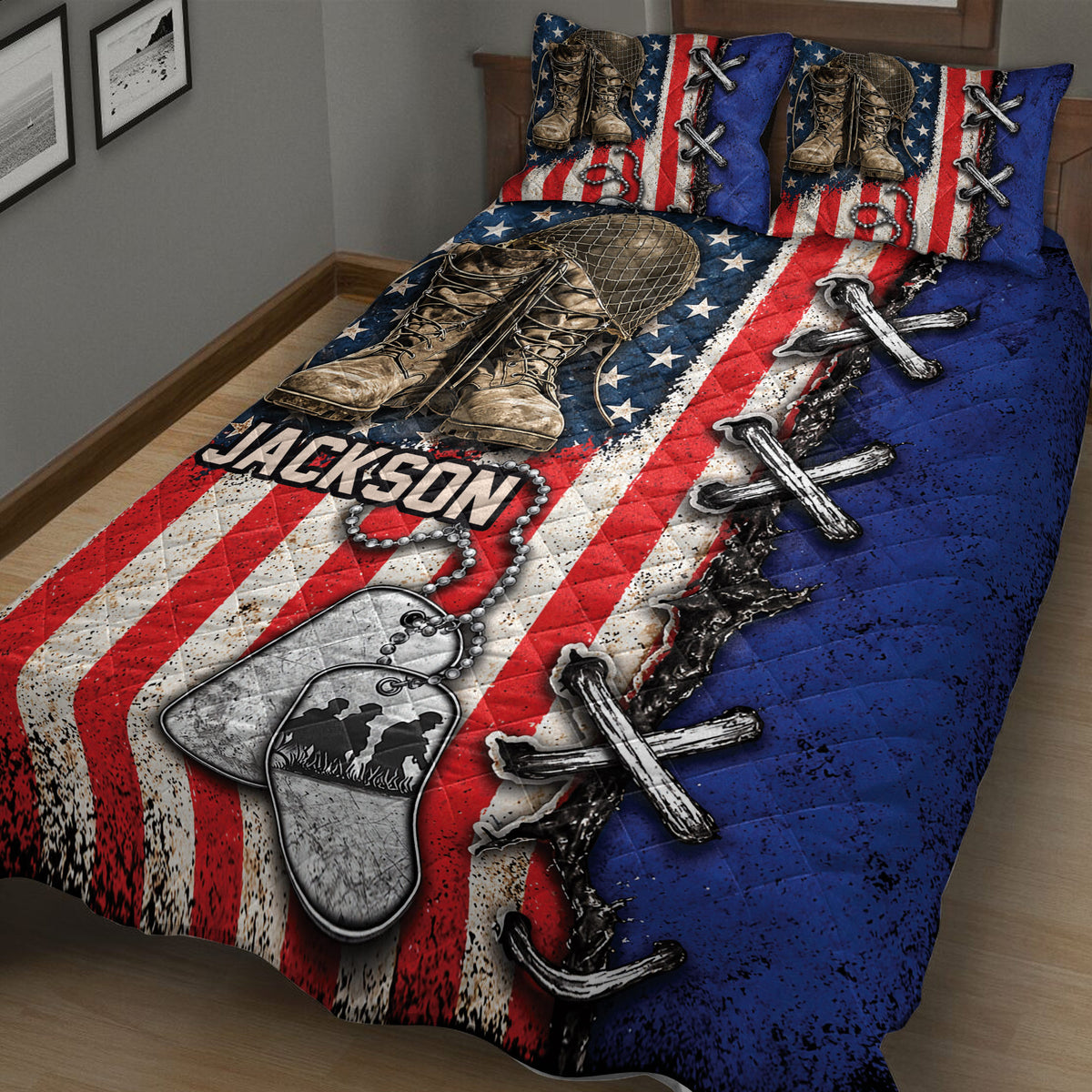 Close bedroom view of a veteran quilt blanket featuring combat boots, dog tags, crossed rifles, stars, and red, white, and blue stripes