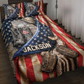 Veteran quilt blanket displayed on a bed with camouflage gear, combat boots, dog tags, stars, and patriotic flag artwork