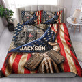 Veteran quilt bedding styled in a bedroom with camouflage gear, combat boots, dog tags, and red white and blue stars