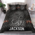 Fishing-themed quilt bedding styled in a bedroom with large hook artwork and dark outdoor-inspired details