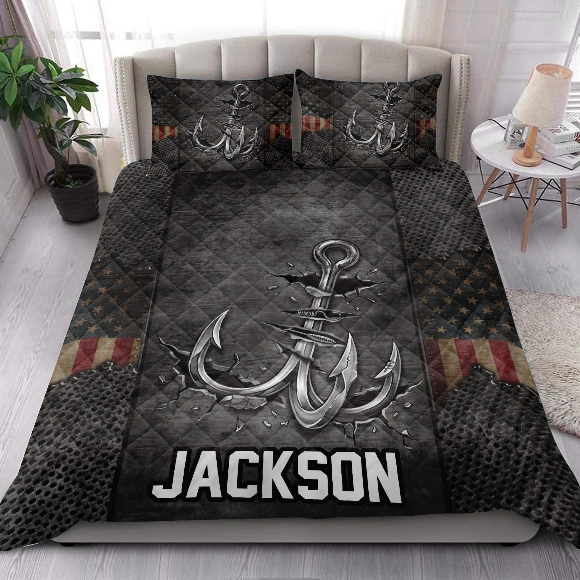Fishing-themed quilt bedding styled in a bedroom with large hook artwork and dark outdoor-inspired details