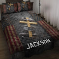 Christian cross quilt blanket with distressed patriotic stars and stripes displayed on a bedroom bed