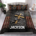 Christian cross quilt blanket styled across a modern bedroom with patriotic stars and stripes