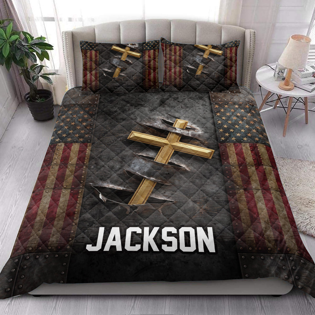 Christian cross quilt blanket styled across a modern bedroom with patriotic stars and stripes