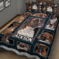 Close view of a Boxer dog quilt blanket featuring multiple framed dog portraits in a bedroom