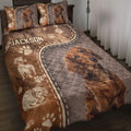Dachshund quilt blanket spread across a bed with paw prints, dog portraits, and warm brown bedroom artwork