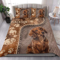 Dachshund quilt bedding styled on a bed with large dog portraits, paw prints, and brown rustic decor