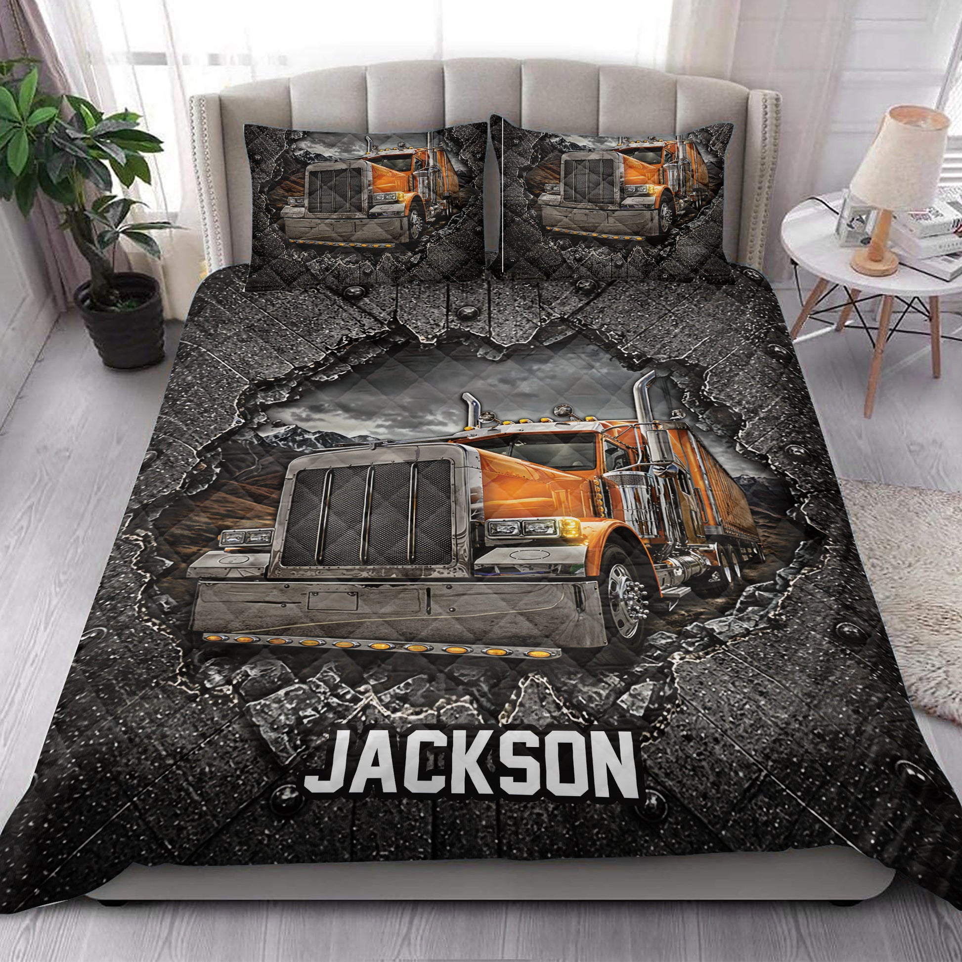 Trucker quilt blanket styled on a bed with dramatic orange semi-truck artwork and dark industrial decor