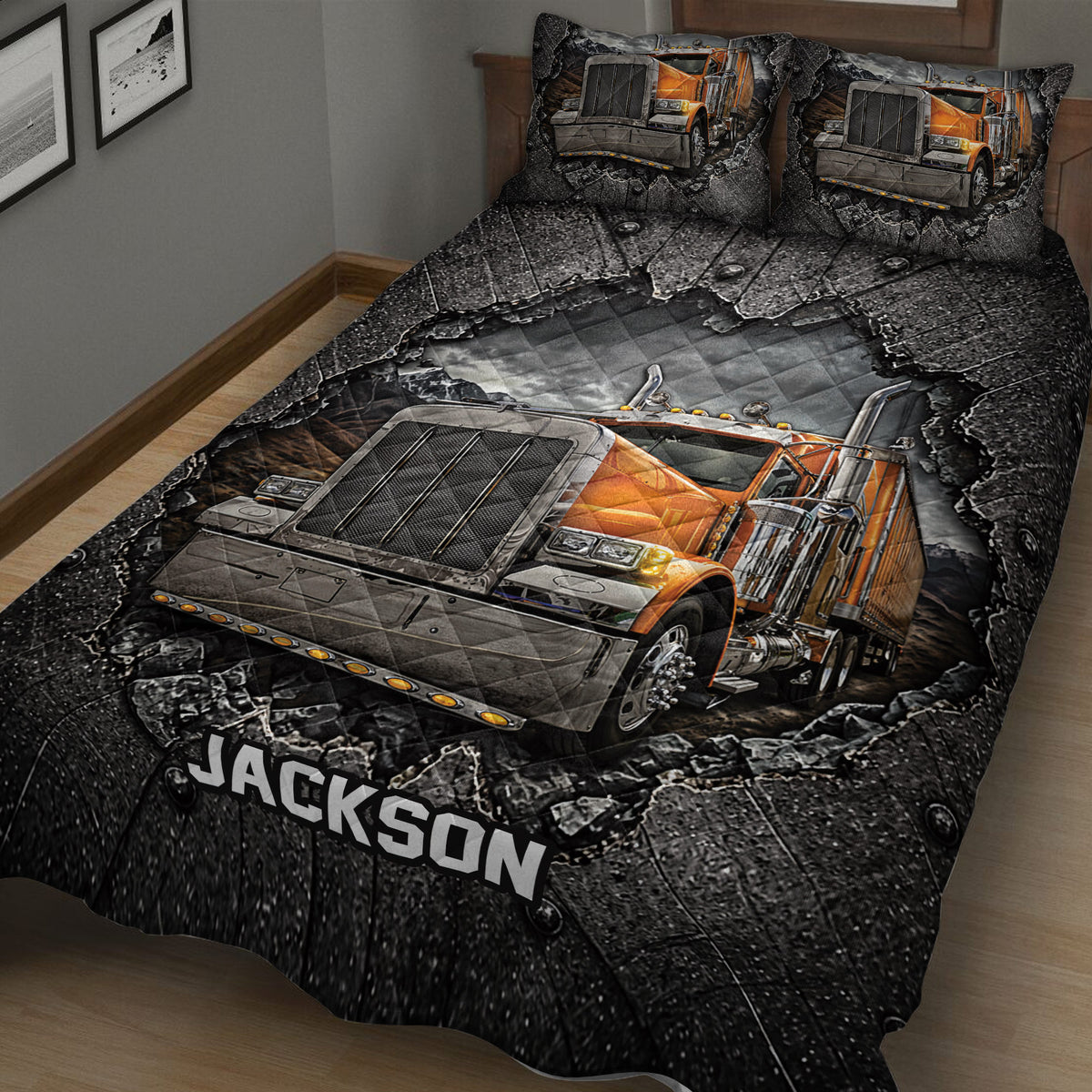 Close-up of a trucker quilt blanket featuring a large orange semi-truck against a rugged black background
