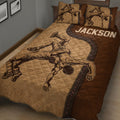 Close bedroom view of a wrestling quilt featuring two grapplers and a quilted brown design